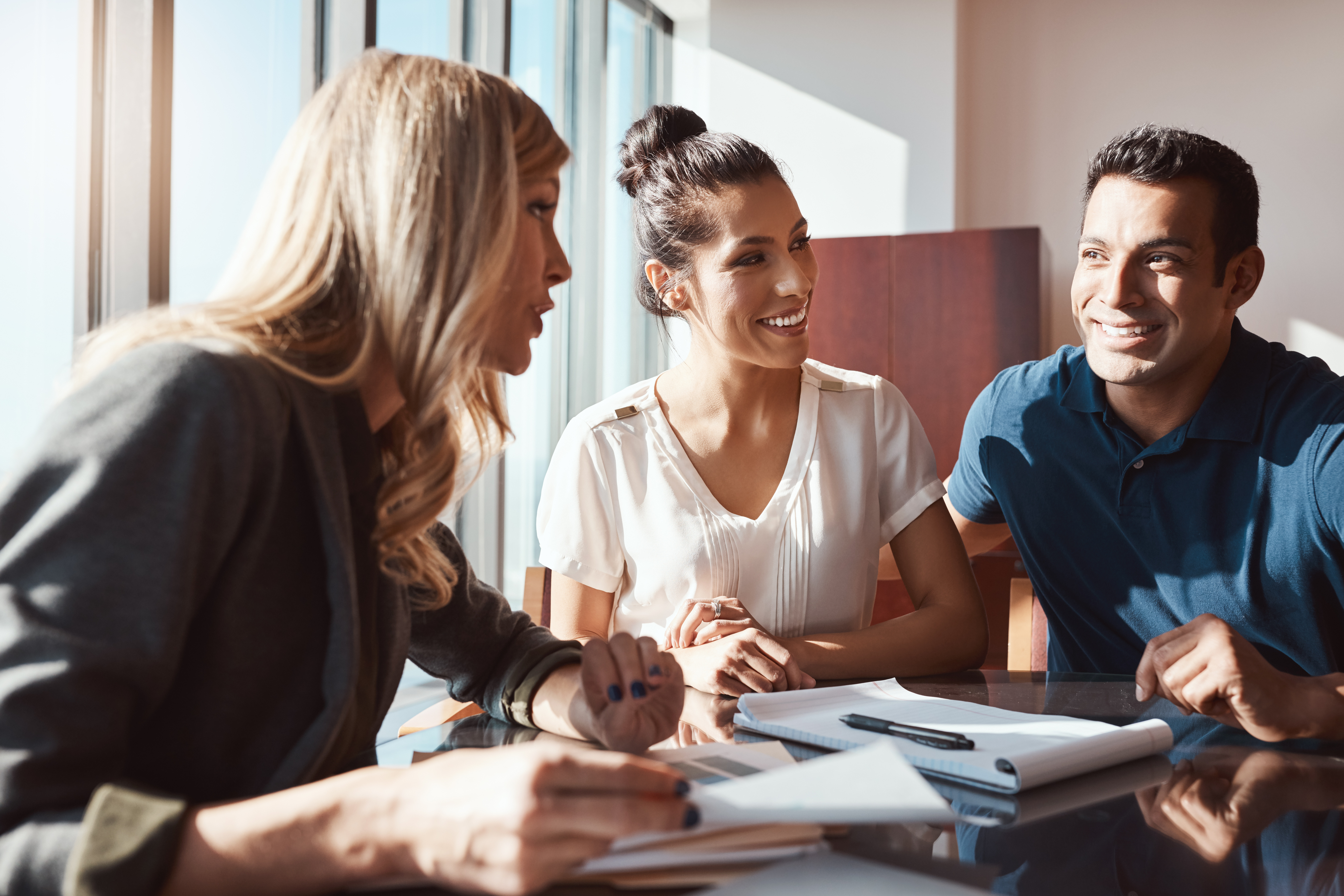 three colleagues discussing IT policies
