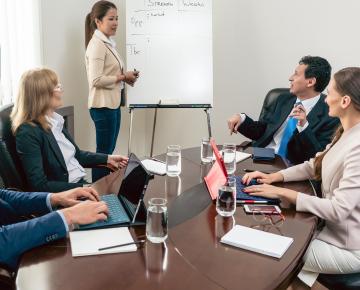 team of colleagues sitting around a table at a meeting
